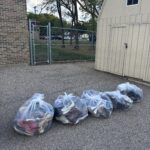 Five large bags of shoes that have been donated.