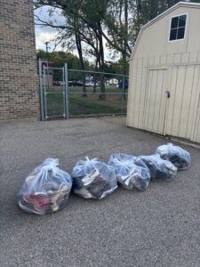 Five large bags of shoes that have been donated.