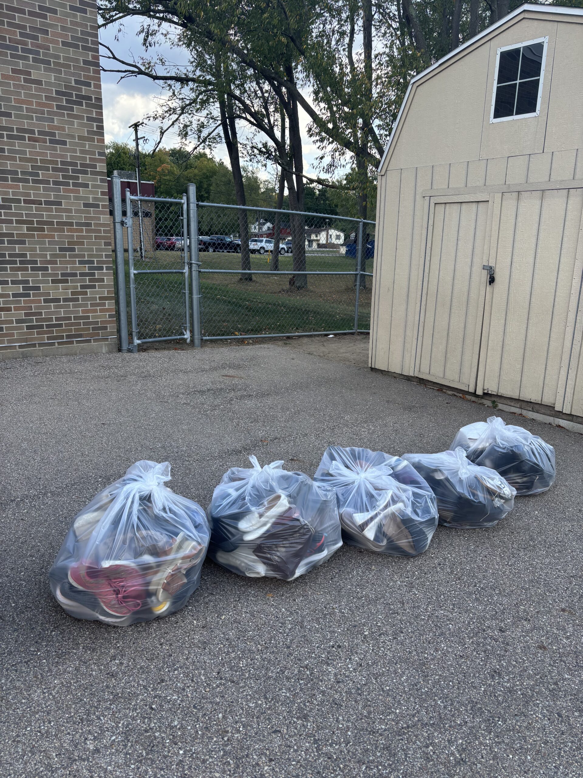 Five large bags of shoes that have been donated.
