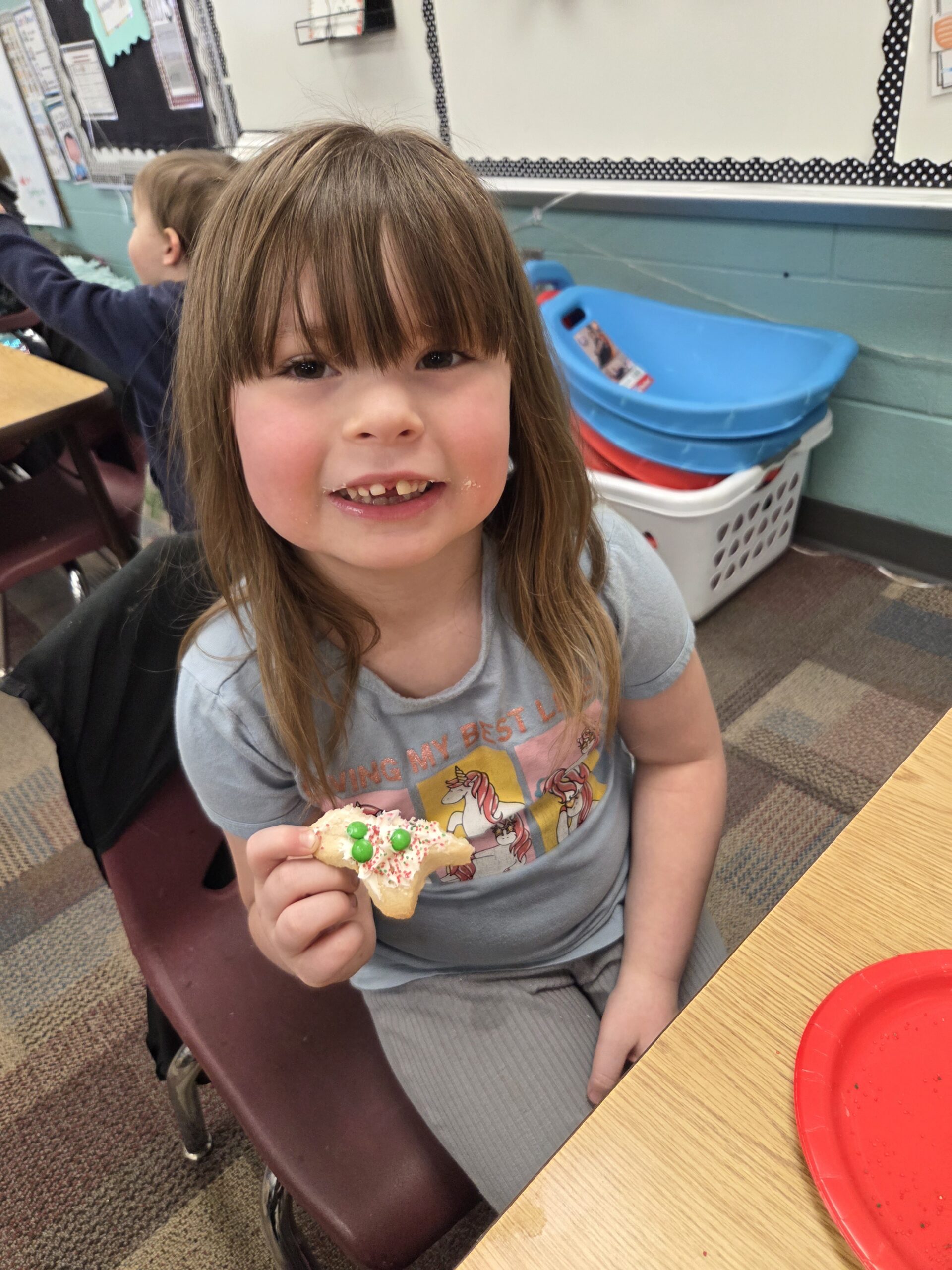 A student enjoying a cookie she decorated.