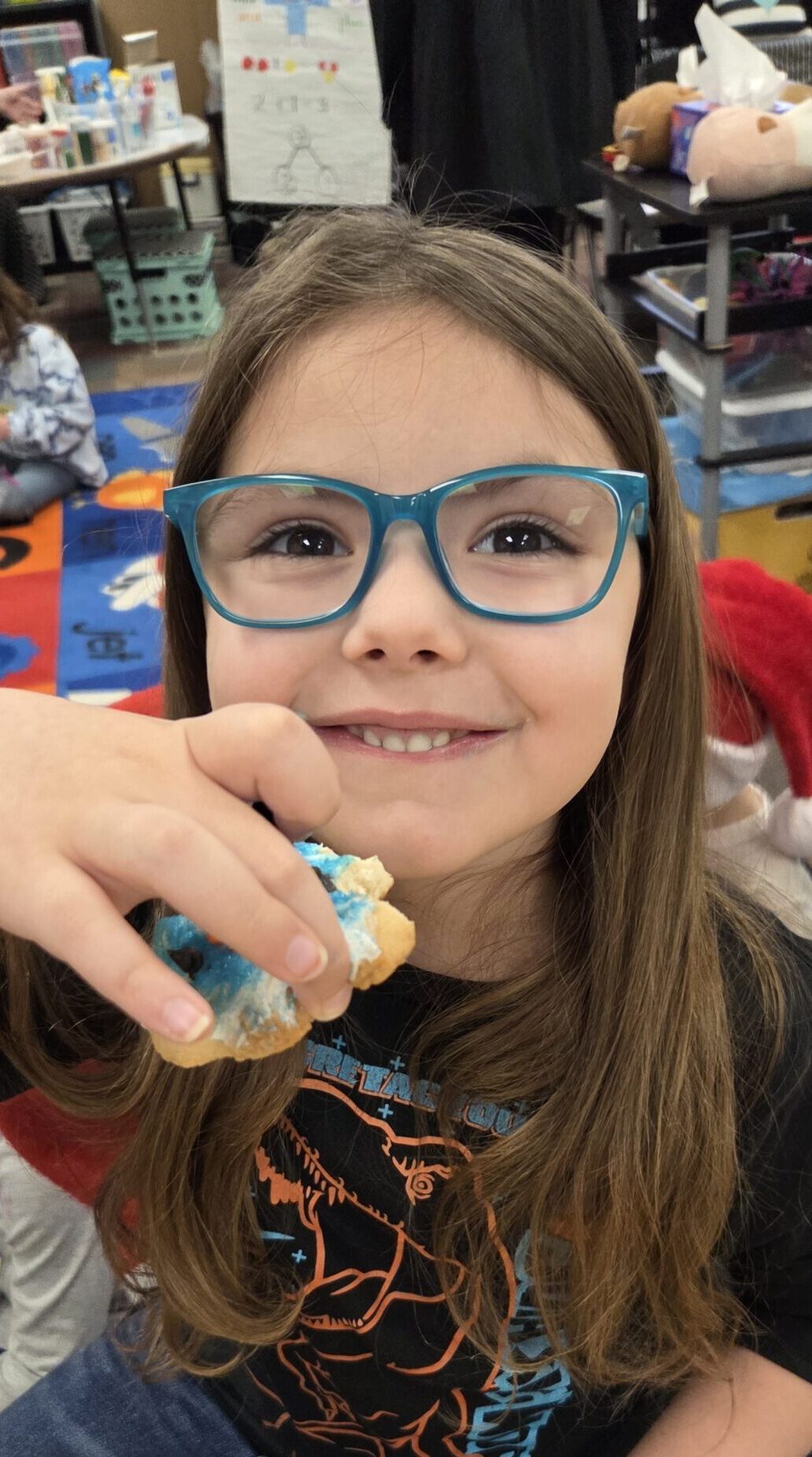 A student enjoying a cookie she decorated.