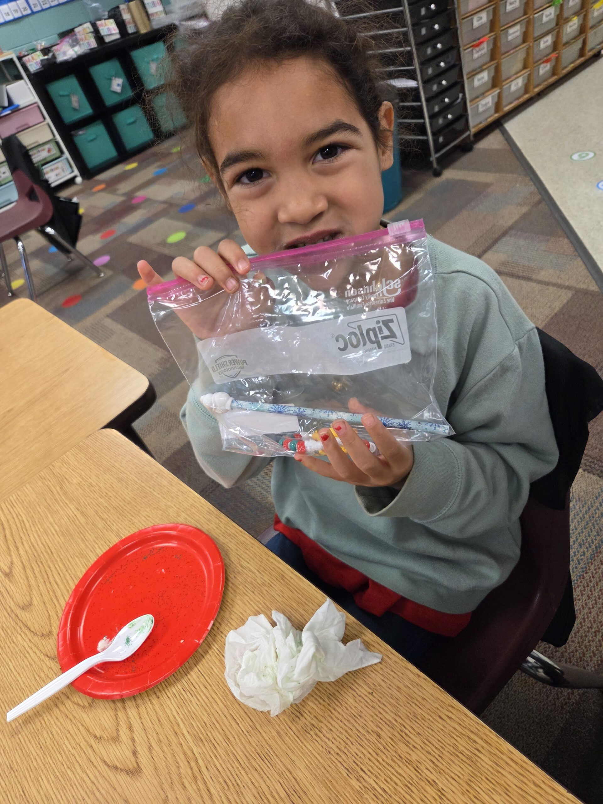 A student with a bag of goodies from Jingle bell bash.