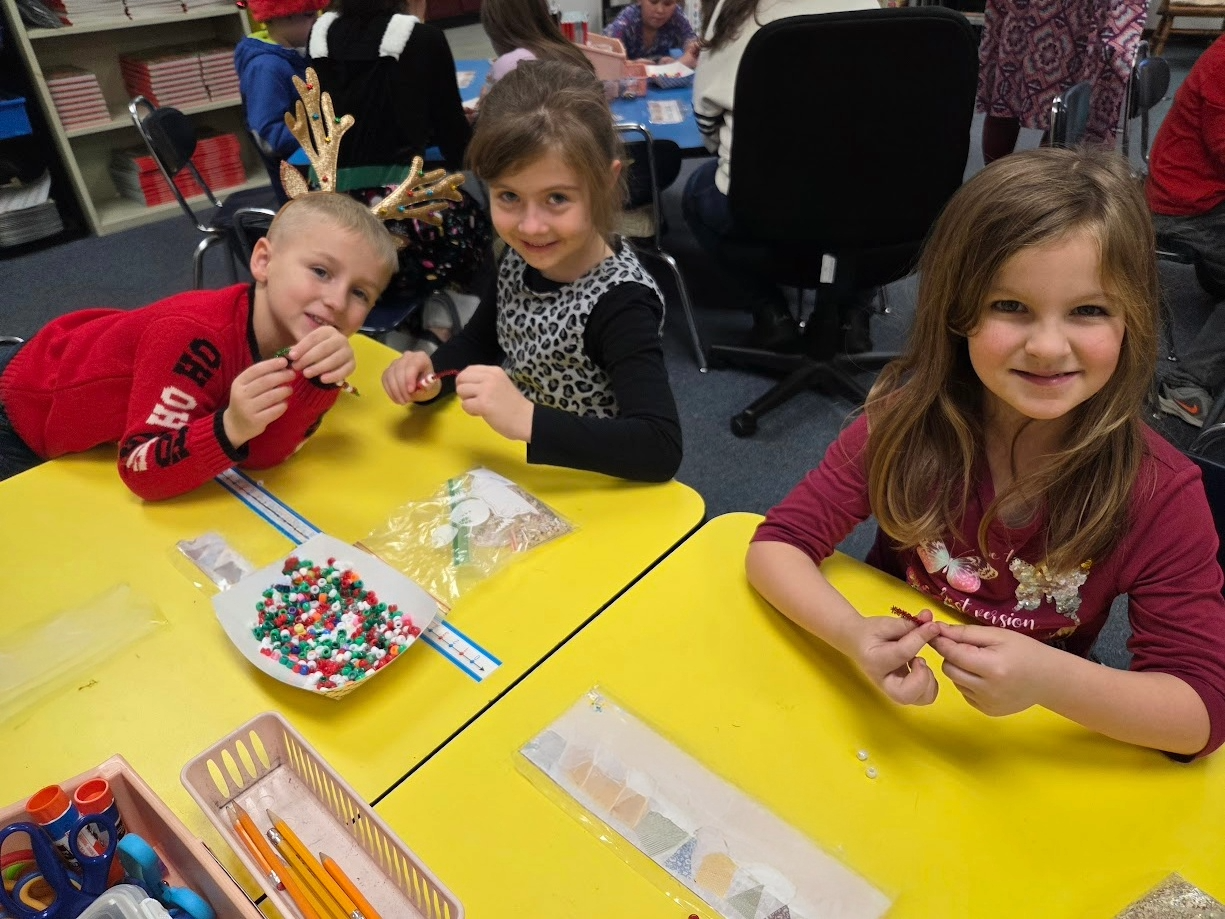 Students doing a bead craft.